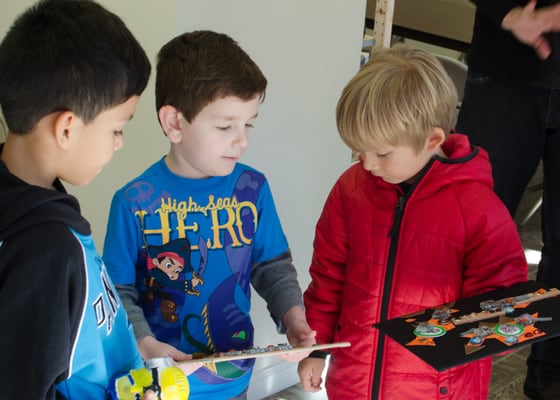 Children discuss their artwork after class