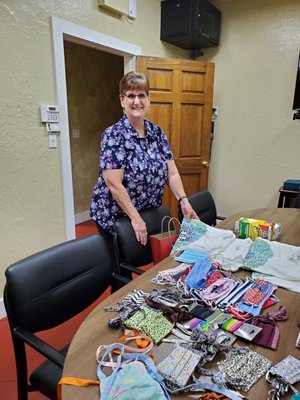 Caregiver Darla picking out some handmade masks.