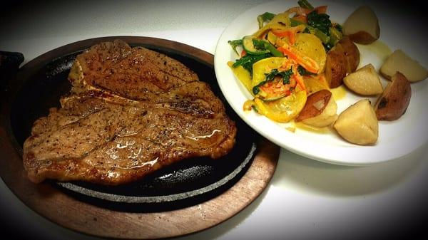 Steak a la Tampiqueña. Our t-bones are served with two sides of your choice . Cooked as requested.