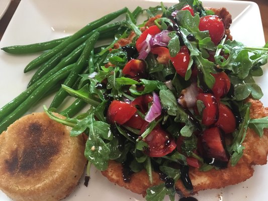 Chicken Milanese topped with organic baby arugula, cherry tomatoes, red onions and balsamic glaze