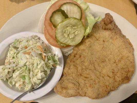 Half of a tenderloin with some sweet slaw.