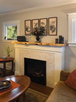 Wood from a tree salvaged on the property was used to create a custom live edge mantel for the living room fireplace