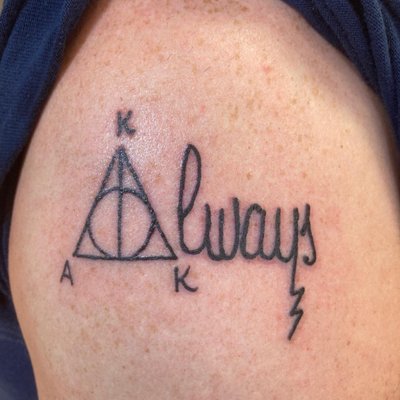 Tattoo of "Always" from Harry Potter with my wife's and 2 daughters' first initial around the "Deathly Hallows" symbol