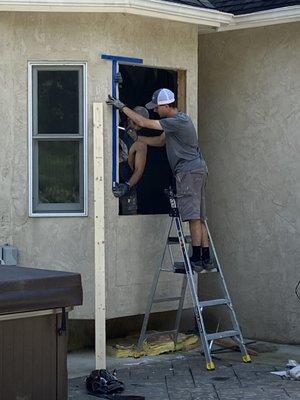 Opening being enlarged by Exterior One Master Installers to install a full glass out-swing Provia entry door with internal blinds.