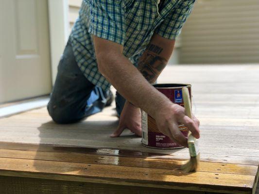 Applying a natural tone stain to some cedar.