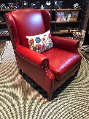 This cozy armchair will be sure to make a bold statement in any family room. I'm loving all of the Makenzie Child pieces here!