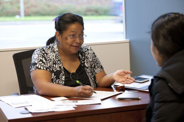 Lore Mendoza helping a patient with OHP enrollment