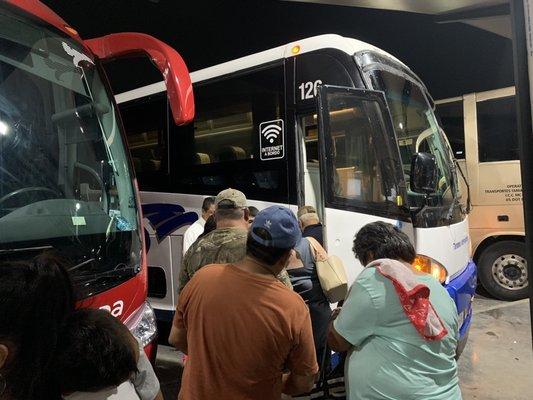 Finally the bus has arrived, and instead of forming a line people are just walking towards the bus because of how late they were