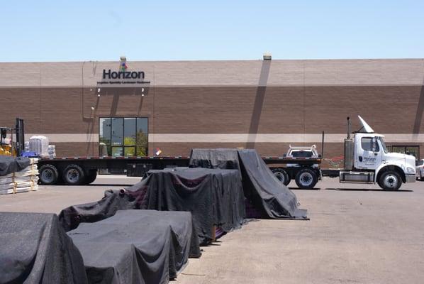 Large Horizon delivery truck just in front of the entrance on the east side of the building.