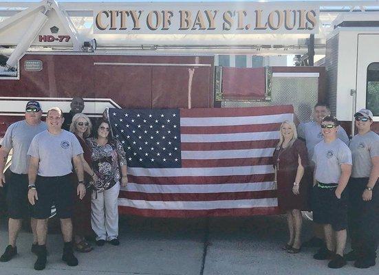 WoodmenLife Representatives Elizabeth Ladner, Sian Fazende and Kendra Shipman presented Bay St. Louis Fire Dept. with a 5x8 American Flag