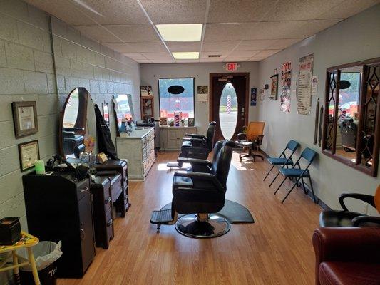 Two Barbers waiting to take care of your needs