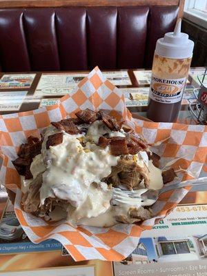 IMG_0158.HEIC  Now this is what I call a loaded potato. Huge potato covered in pork, bacon, and drenched in queso. Yum!