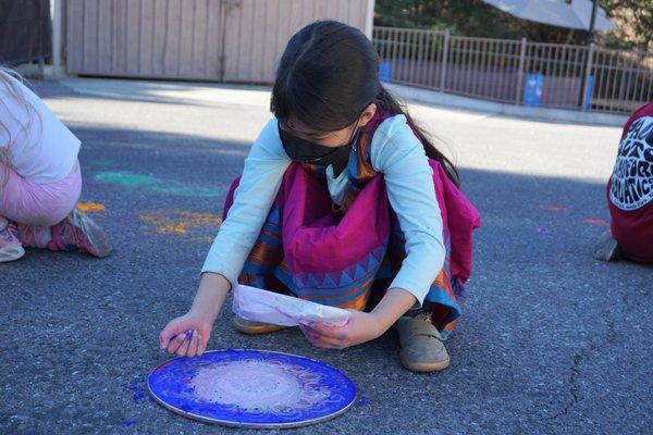 Third graders making rangoli artwork for Diwali