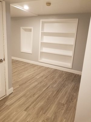 Another part of the finished out basement recessed bookshelf and Vaz display