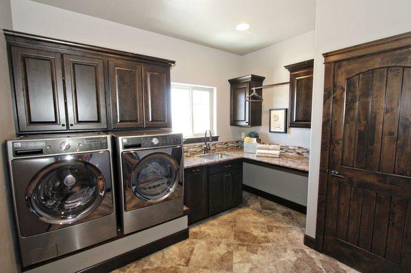 Fabulous laundry space with custom cabinets and granite countertops.