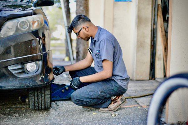 Ryan working on my girlfriends car. I happen to bring my camera along