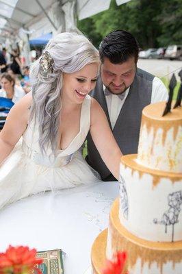 http://www.misssarascakery.com/wedding-cakes.html Hand sketched Disney Themed Wedding Cake.  Topsy Turvy with Golden Pixie Dust. Edible cake