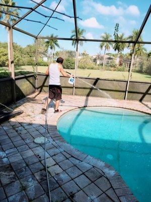 Administering concrete cleaner and letting it deep in before pressure washing starts.