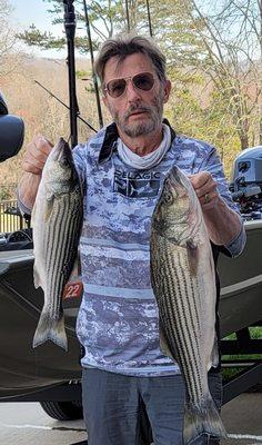 Your captain with a pair of stripers from Lake Nottley