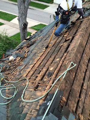 tear off one layer of asphalt shingles and one wood shake, and re-decking the whole roof 