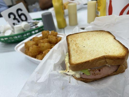 Fried bologna sandwich with tater tot's.