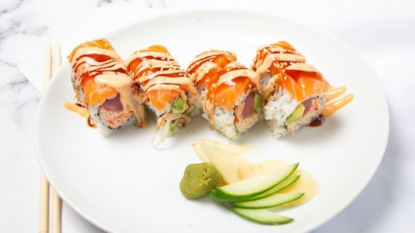 Red Bull Roll: crab meat, fresh tuna, avocado top with fresh salmon and finish with the eel sauce, spicy mayo and masago