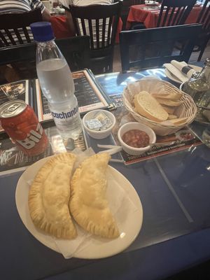 Chilean cheese empanada, Chilean mineral water, and fruit punch Chilean soda can