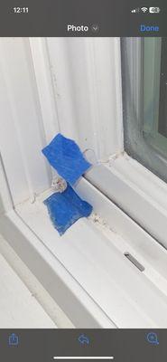 Blue tape to show one of the service me who came in 2021. We had many pieces of blue tape on each window