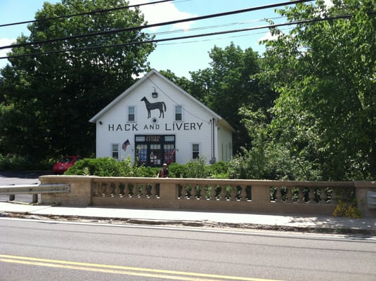 View of Hack & Livery from across the street. They have a big parking lot being those hedges.