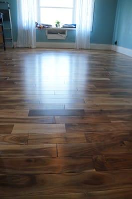 Upstairs floor install by Woodcraft. Natural pre-finished acacia.