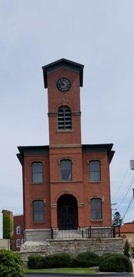 Brick tower with a stone foundation. Wonder what this was.