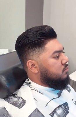 Classic slick back pompadour with a taper and beard trim