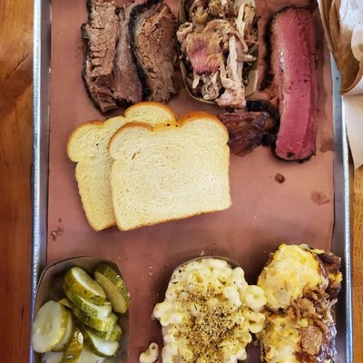 1/4 LB of brisket, pulled pork, pastrami, one rib, Mac and cheese, tater tot casserole, housemade pickles