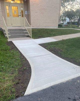 Concrete walkway for safe entry into building. We offer a wide variety of Concrete Walkways & Patios, Retaining walls, Foundations, & more!