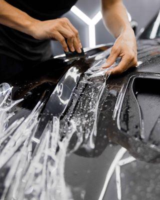 Stek 10-year warranty paint protection film being applied Porsche.