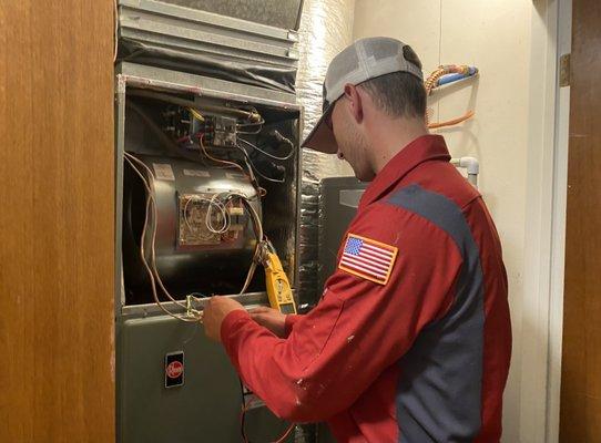 Our technician Zach working on a customer's furnace