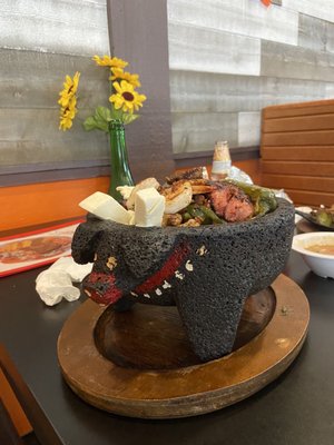 Molcajete: steak, chicken, chorizo, shrimp, sausage and cheese with warm home made tortillas, rice and beans on the side.