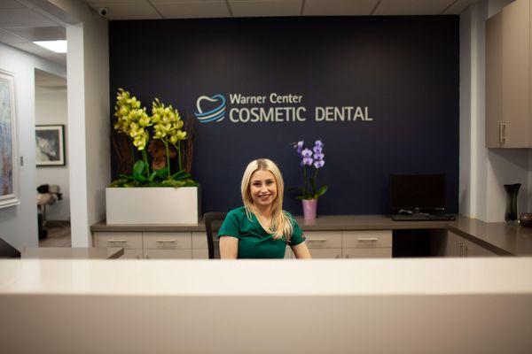 Our receptionist smiling at our front desk.