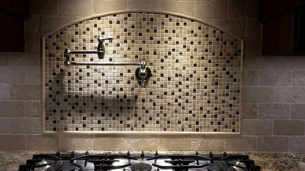 Custum pot filler and natural Stone backsplash installation.