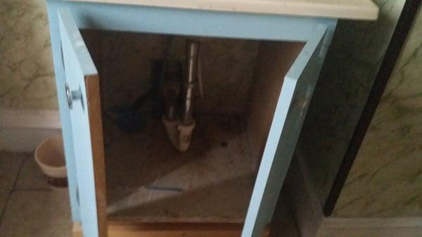 Big hole in the back of bathroom vanity. Never fixed.