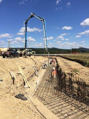 Using Concrete pumper truck for the foundation pour for Concrete Retaining wall @ Loves Sleep Inn, Cumberland Md.