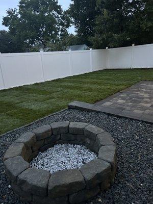 Full landscape project . White fence , fireplace, and patio