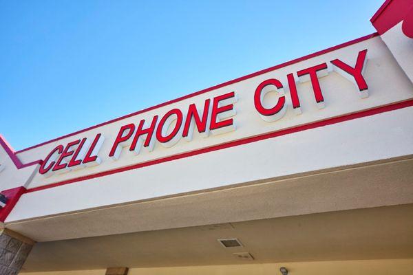 The sign on the front of Cell Phone City in Northcrest Shopping Center (Next to Five Guys)