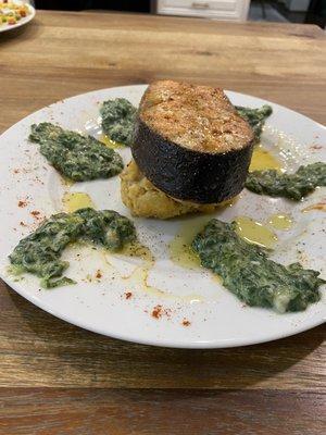 Salmon steak roasted potatoes and creamy spinach.