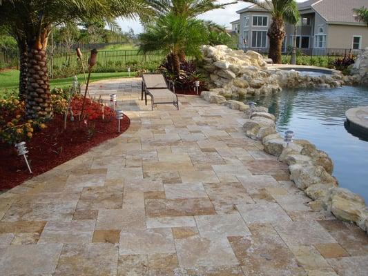 Gold Travertine pavers on a residential pool deck.