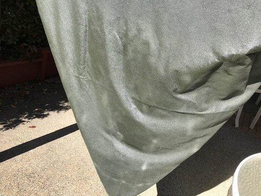 "Heavy Duty" Canvas tarp sweats black waxy substance in the sun even in 66 deg. weather.