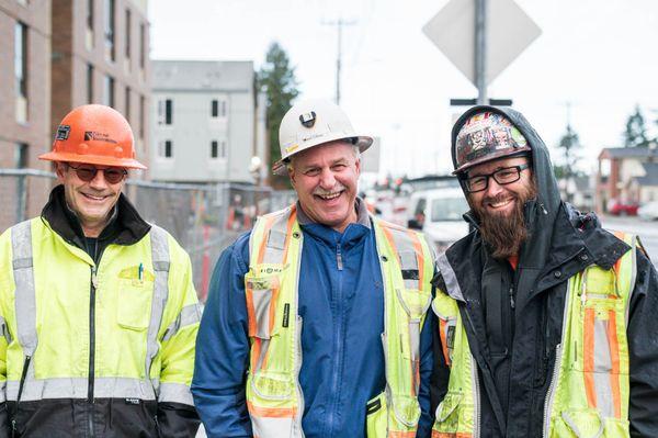 construction professionals pose together on the street in Portland Oregon