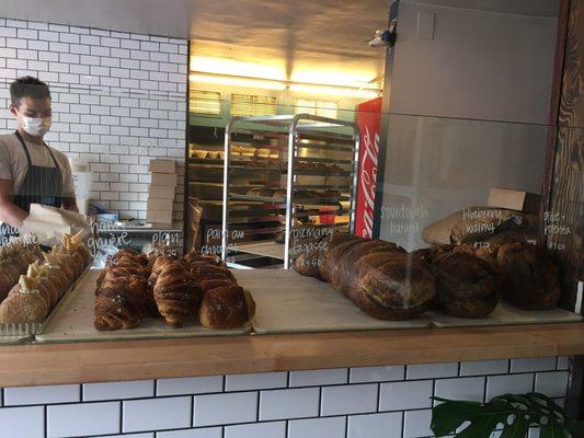 A selection of baked goods including fancy doughnuts and ham gruyere croissants