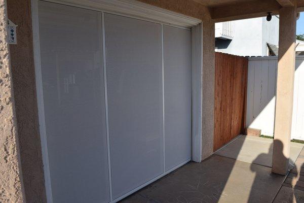 The Screen Machine's Finished Installation of the Lifestyle Single Car Garage with White Privacy Screen (view looking into garage)