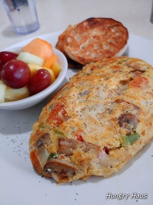 Veggie Omelette with Swiss and fruit cup vs hashbrowns.